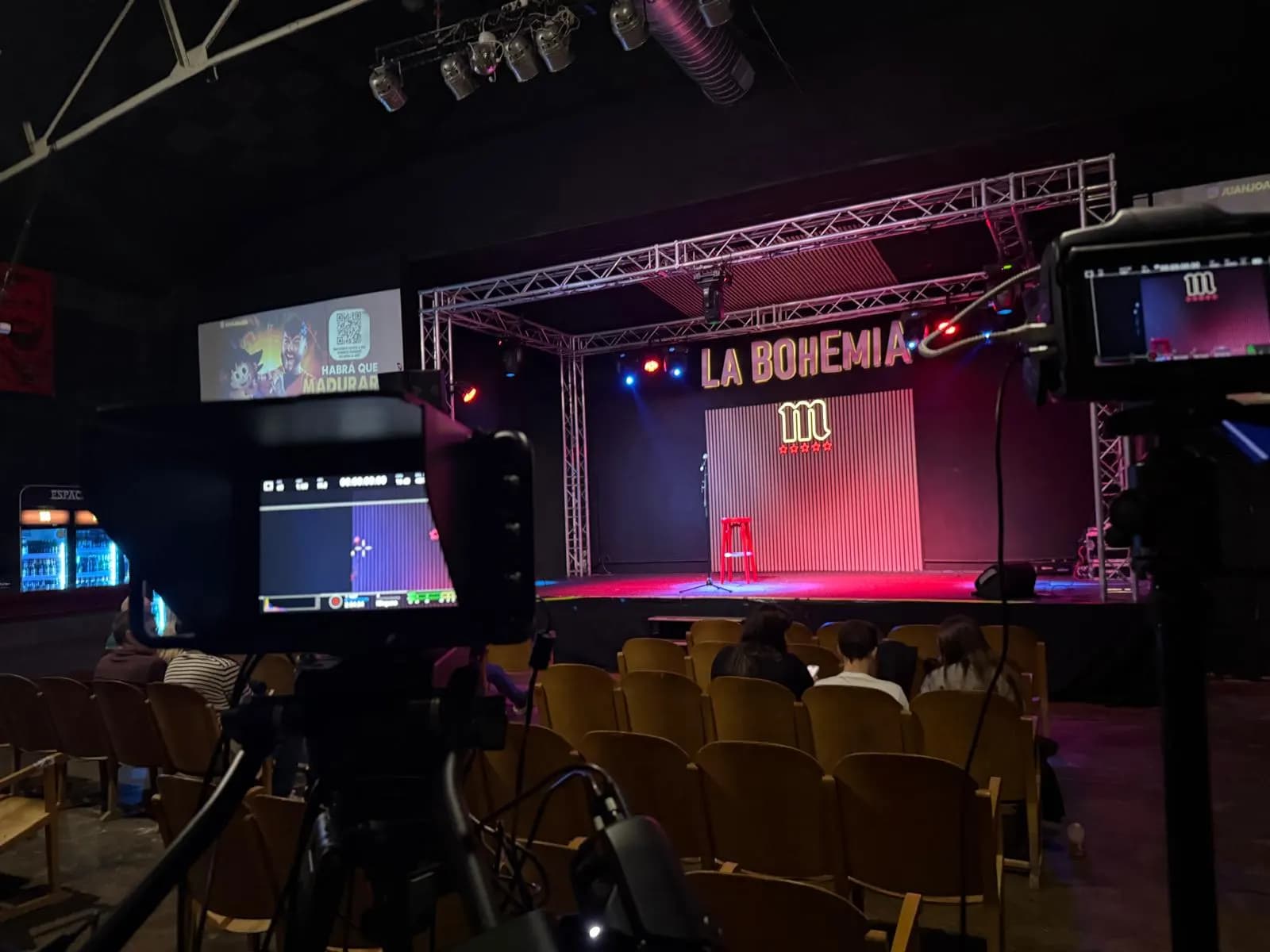 Two cameras on tripods with their monitors pointing at the La Bohemia stage, still empty
