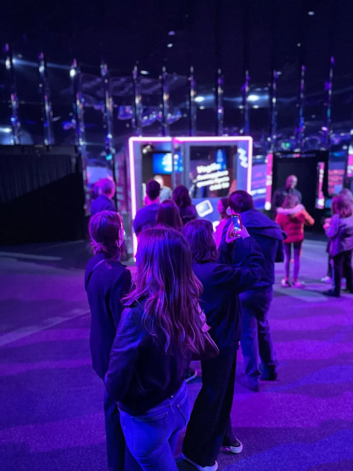 Guests in front of the lit karaoke booth in the Sky event space